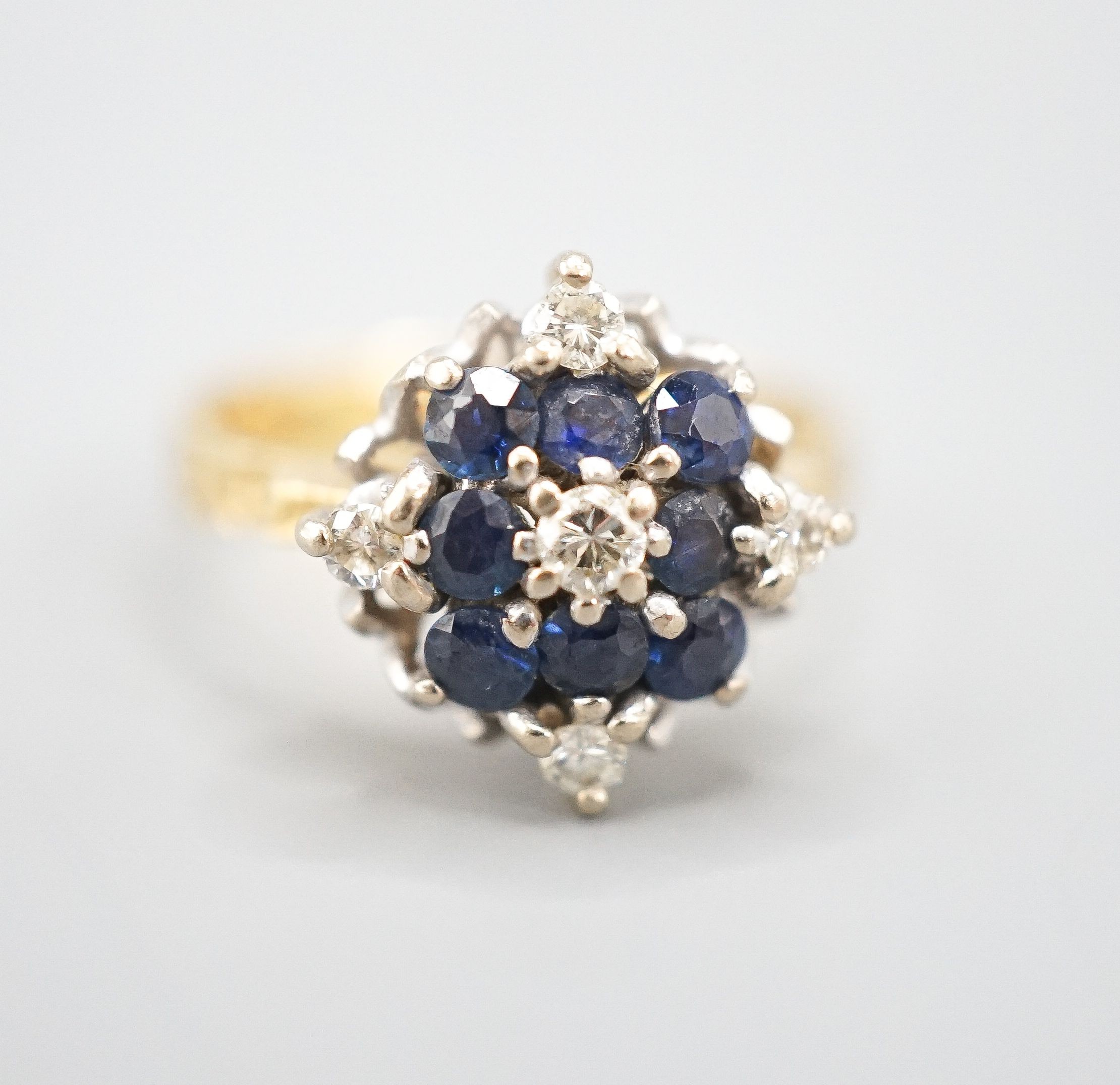 A 1960's 18ct gold, sapphire and diamond cluster ring, size Q, gross weight 5.8 grams.